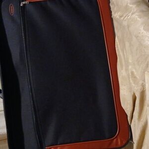 Large oversized black suitcase with red panels on the side with handle free ship